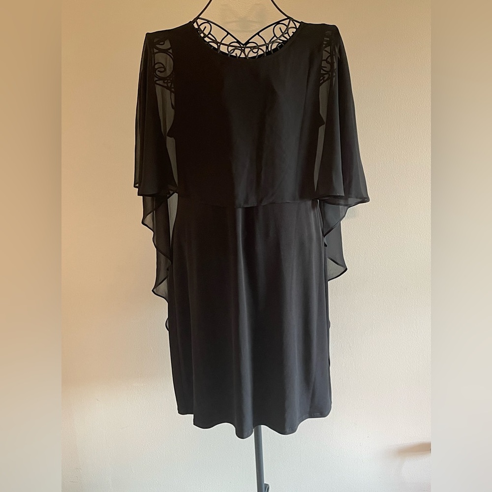 Black cocktail dress with sheer cape.
